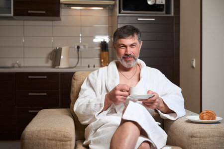 Portrait of man spending morning in hotel roomの写真素材