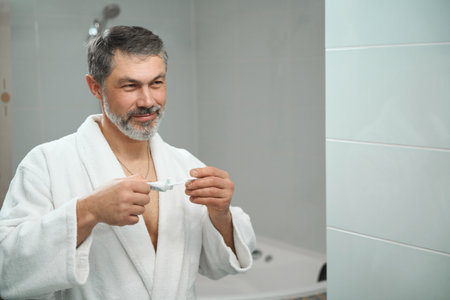 Man getting ready to brush teeth in hostelの写真素材