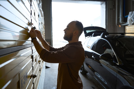 Focused adult male opening the lock from the luggage locker