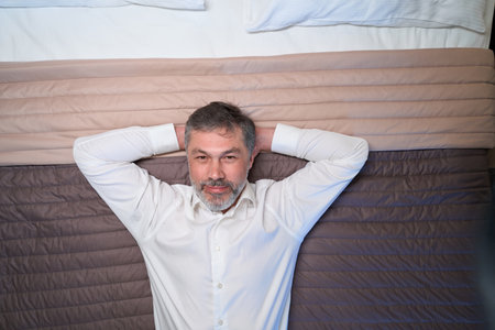 Close up photo of man lying on bed