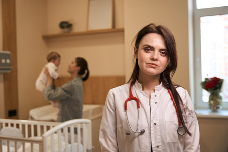 Female pediatrician posing for camera during morning roundの写真素材