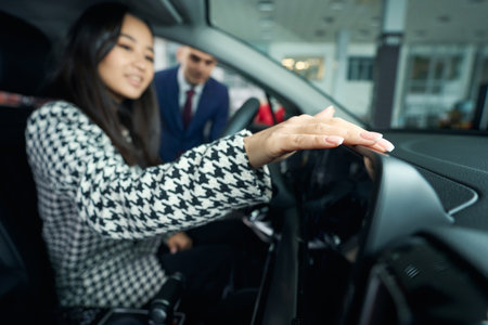Pleasant customer is happy to inspect complete set of carの写真素材