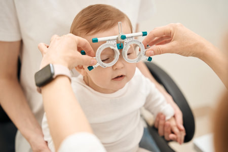 Pediatric optometrist preparing baby for visual acuity testの写真素材