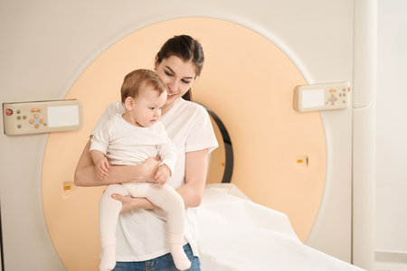 Cheerful female with her baby before magnetic resonance imagingの写真素材