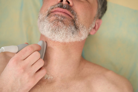 Doctor performing ultrasound examination of neck in the clinic