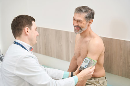 Doctor putting on tonometer on patient arm