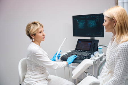 Gynecologist is preparing to diagnose patient using vaginal ultrasound device