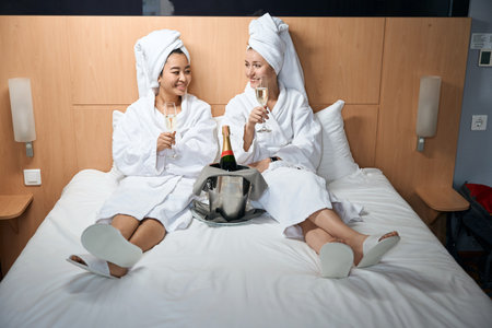 Women with towel on their heads and in white coatsの写真素材
