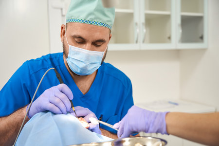 Doctor phlebologist performing surgery with radio wave knife in hospitalの写真素材