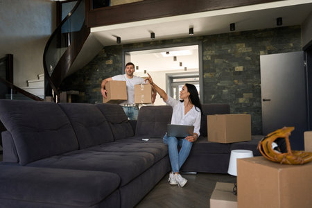Girl shows the man where to carry the boxes