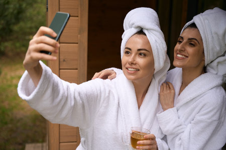 Young women taking pictures on the phoneの写真素材