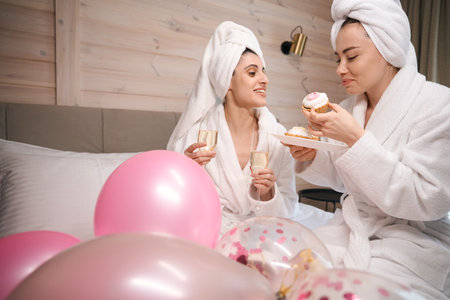 Happy women having fun celebrating birthday partyの写真素材