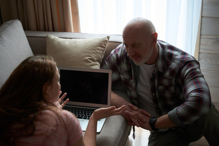 Female having conversation with her spouse at homeの写真素材