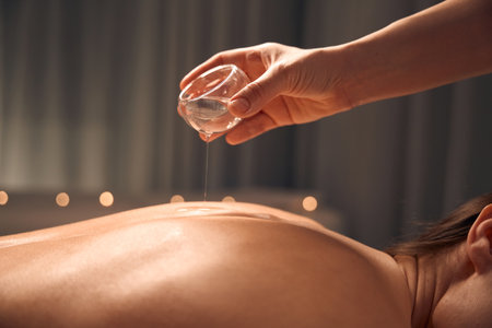 Beauty clinic masseuse preparing client for body massageの写真素材