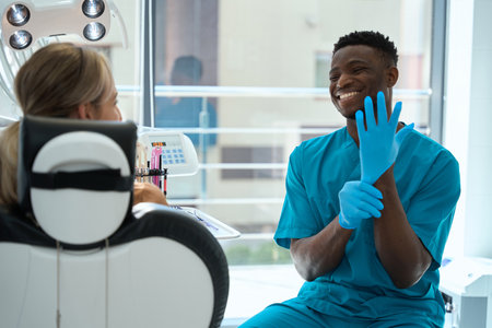 Happy male listening woman, working in hospitalの写真素材