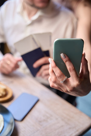 Newlywed couple making selfie holding tickets and passports