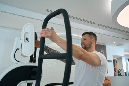Patient undergoing physical rehabilitation on modern fitness equipment