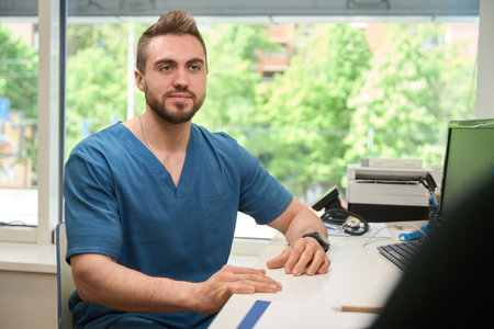 Qualified physician receiving adult person in his officeの写真素材