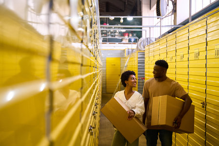 African American guy and girlfriend with cardboard boxes