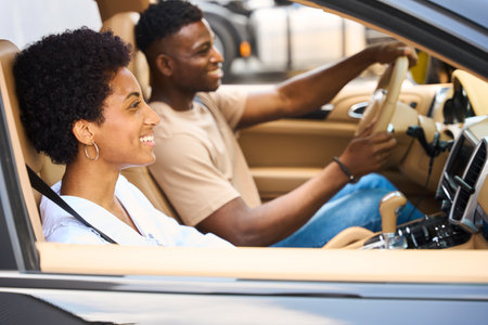 Happy African American couple traveling in a comfortable car