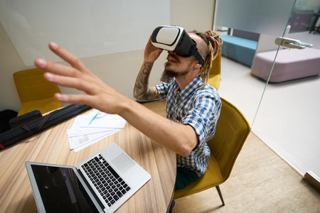 Informal guy uses a virtual reality headset