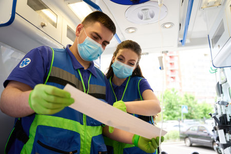 Paramedics study the cardiogram of the victim