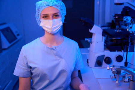Lab researcher is posing for camera in her workplaceの写真素材