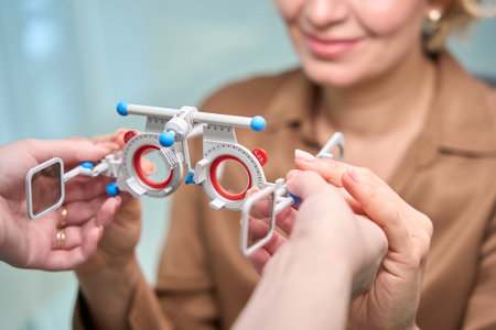 Employee of an optical salon uses professional device at work