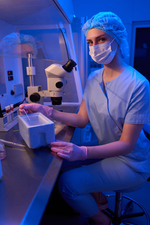 Cryopreservation expert freezing cells in cryogenic freezer boxの写真素材