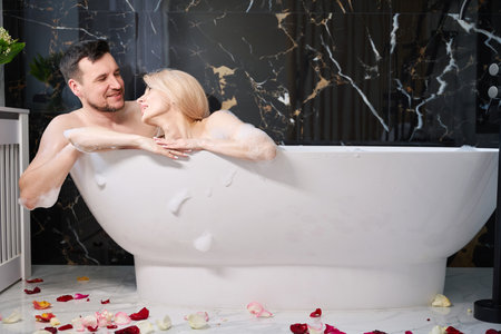 Happy newlyweds enjoying a warm bath