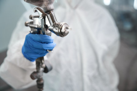 Person with a paint injection tank in his handsの写真素材