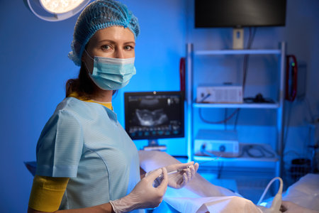 Female doctor using syringe for artificial fertilization in reproductive clinicの写真素材