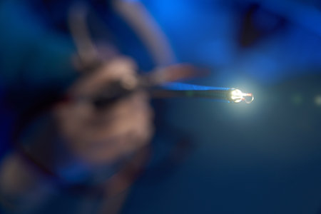 Close up of lighting hysteroscope in hands of blurred male doctor in clinic