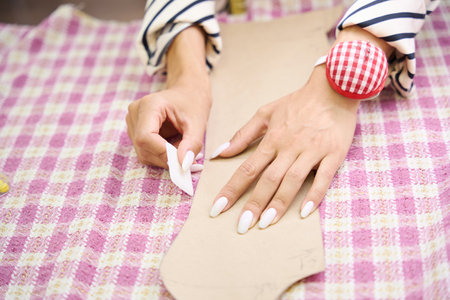 Woman at the workplace is working with a checkered fabric