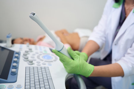 Ultrasound equipment using gynecologist doing examination to blurred womanの写真素材