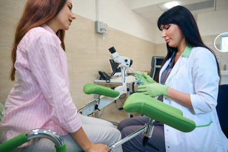Female gynecologist preparing gynecological mirrors with exhaust pipes for womanの写真素材