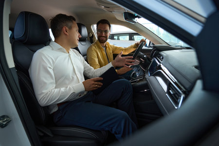 Client with a consultant in the interior of modern car