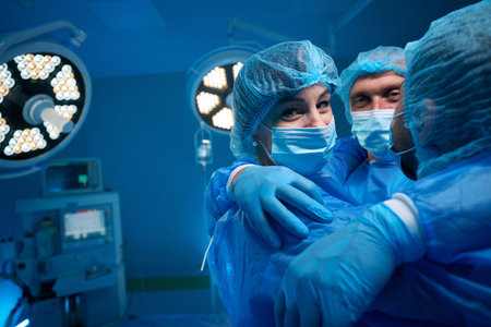 Successful surgical team hugging in surgery theaterの写真素材