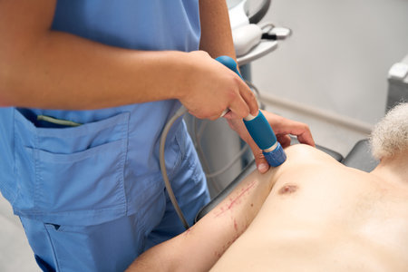 Rehabilitation therapist works in a clinic with a middle-aged patient