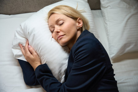Tired female entrepreneur is dozing in her bedroom