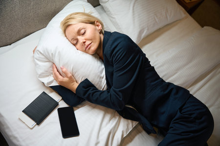 Weary business lady is napping in her suite upon arrival