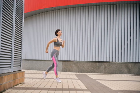 Young woman on morning activity, jogging outside