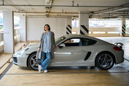 Young female parked new car at parking