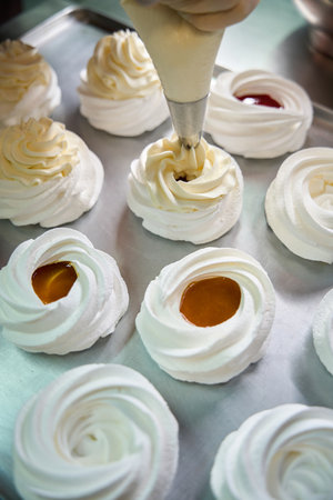 Top view preparation of delicious appetizing mini Pavlova dessert
