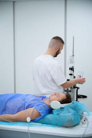 Radiographer is preparing adult man for contrast-enhanced MRIの写真素材