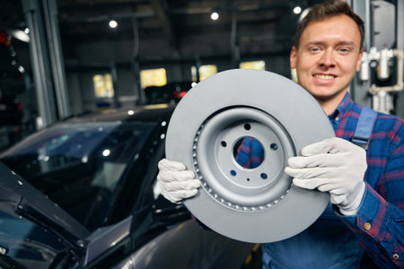 Man holding disc in the car service centerの写真素材