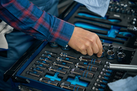 Professional worker choose instruments for repair in tire fitting