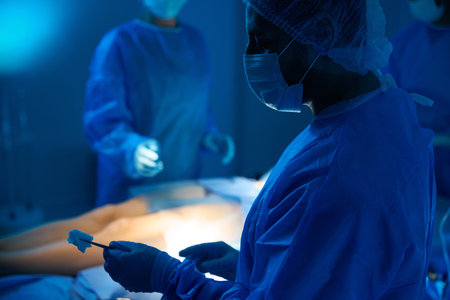 Doctor surgeon with sterile equipment doing operation for female patient