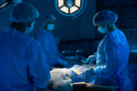 Team of professional medical surgeons performing surgery in operating room