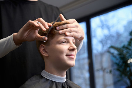 Photo of handsome boy in modern hairdressing salonの写真素材